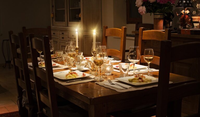A dad is sitting at the dinner table with his kids.